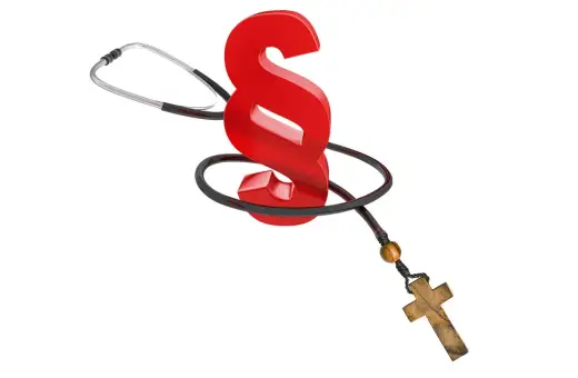 Czerwony znak paragrafu opleciony stetoskopem i różańcem symbolizuje klauzulę sumienia w medycynie.